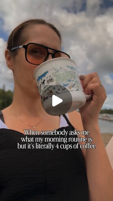 Ashley Ann holding a community mug outdoors